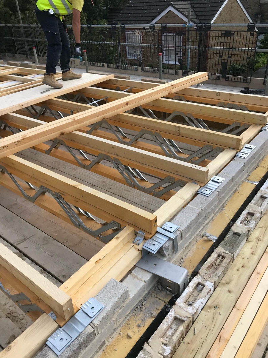 Posi-joist floor structure with joist hangers on blockwork