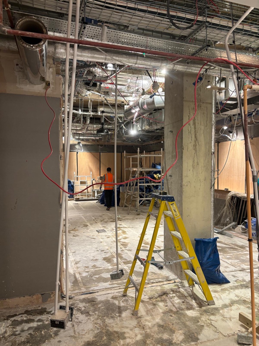 Commercial fit-out with exposed services ceiling and ductwork mid strip-out